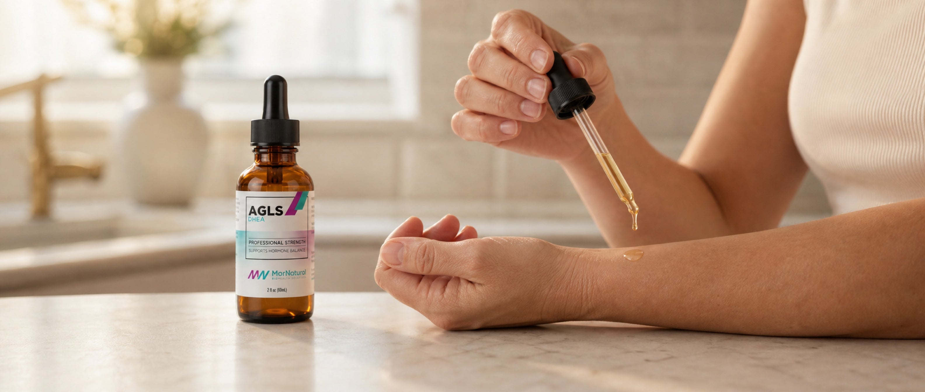 AGLS DHEA Oil bottle with dropper being applied to the inner forearm